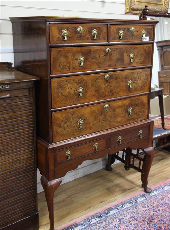 A George II featherbanded walnut chest on later stand, W.3ft 7in. D.2ft H.5ft 1in.